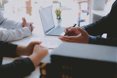 Legal consultation taking place at a desk. 